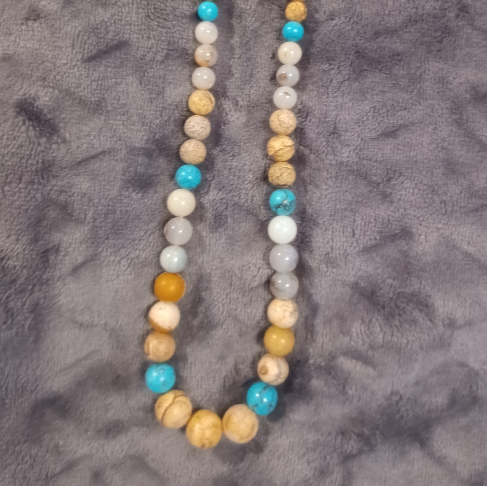 Turquoise & tan & brown bead necklace. I'm not sure what the other beads are.